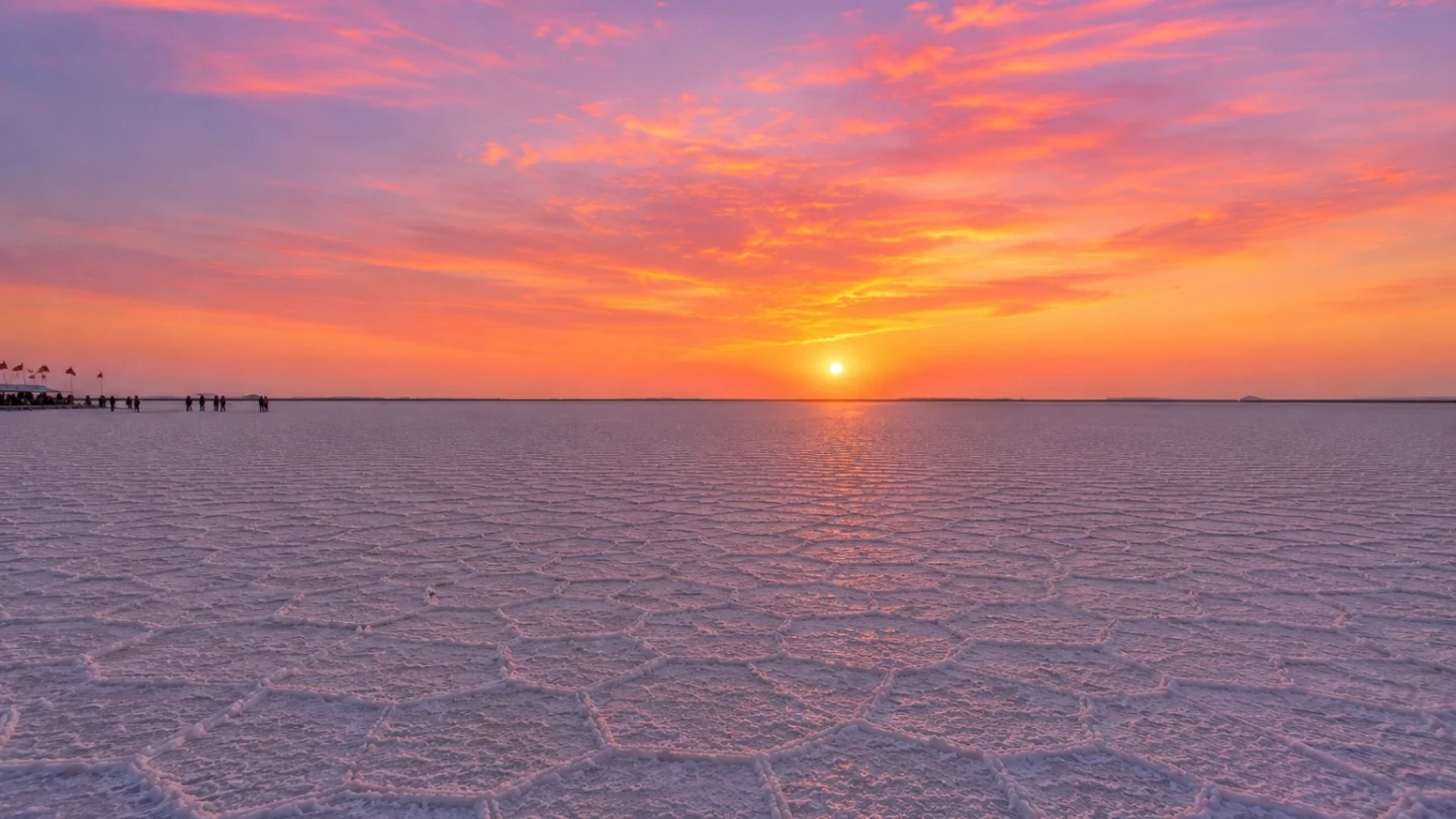Wide view of the White Rann of Kutch at sunset with pink and orange sky, part of Rann Utsav package from Ahmedabad