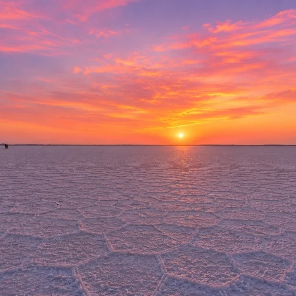 Wide view of the White Rann of Kutch at sunset with pink and orange sky, part of Rann Utsav package from Ahmedabad