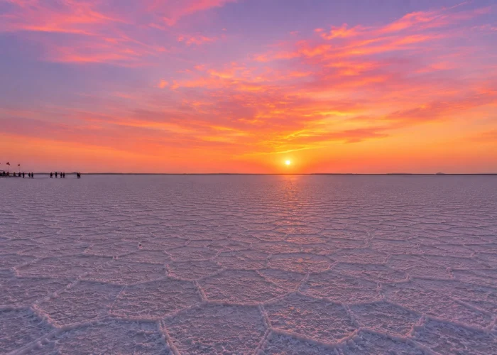 Wide view of the White Rann of Kutch at sunset with pink and orange sky, part of Rann Utsav package from Ahmedabad