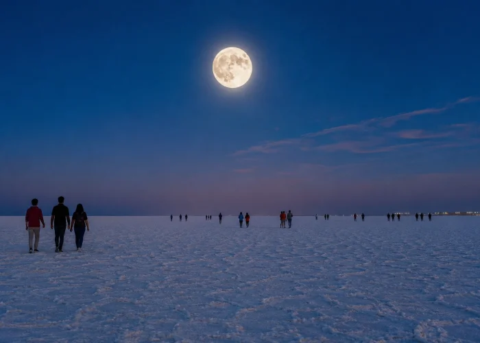 Full moon over the white salt desert with visitors walking